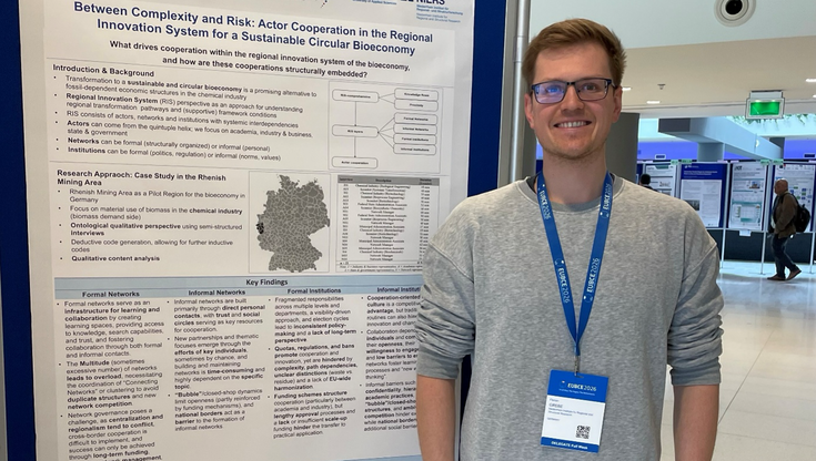 Florian Grebe als Vertreter, vor dem Plakat des Projektes.